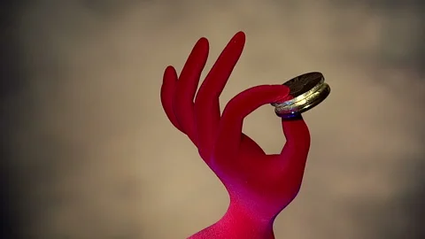 Bitcoins in the fingers of the hand Stock Footage 85760868