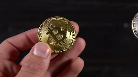 Bitcoins in hands on black background Stock-Footage 87213916