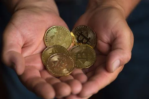 Bitcoins in man hands Stock Photos