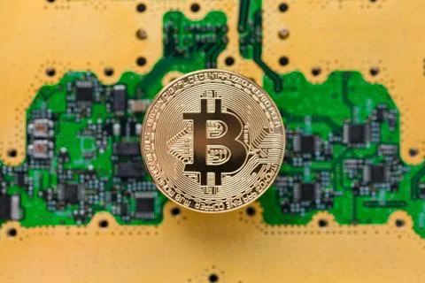 Bitcoins  on the microchip background. Physical bit coins. Digital currenc Stock Photos