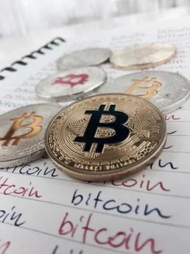Bitcoins in notebook Stock Photos