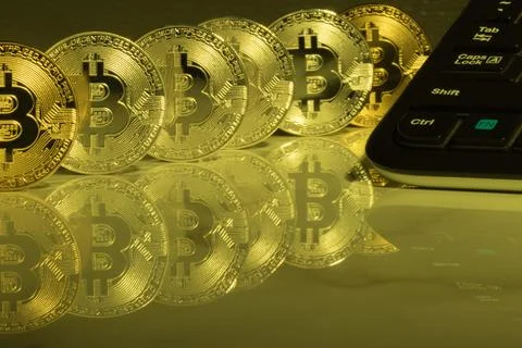 Bitcoins with reflection on marble desk. Electronic money, cryptocurrency. Stock Photos
