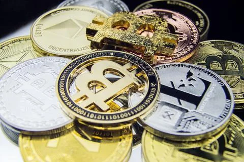 BITCOINS on a reflective surface Cryptocurrency background Stock Photos