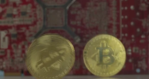 Bitcoins rolling with GPU running on the background symbolizing a Bitcoin mining 스톡 동영상 114781059