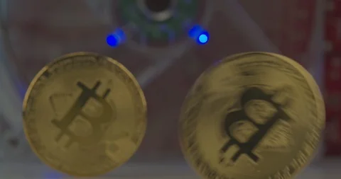 Bitcoins rolling with GPU running on the background symbolizing a Bitcoin mining Stock Footage 114781195