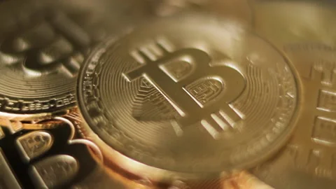 Bitcoins rotating on a gold background, Crypto currency, Macro shot. Stock Footage 161073820