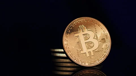 Bitcoins Rotating Slowly with Shallow Depth of Field and Reflection Stock Footage 148311768