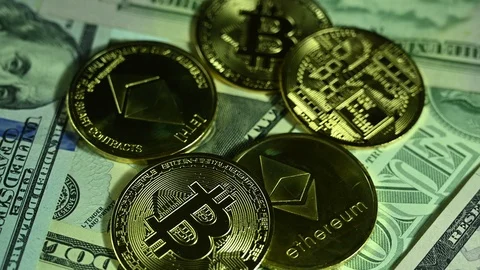 Bitcoins spin on background of dollars Stock Footage 119372066