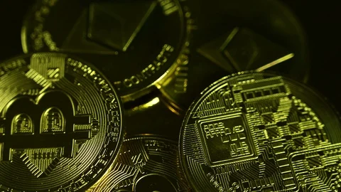 Bitcoins spin on gold background Stock Footage 119371090