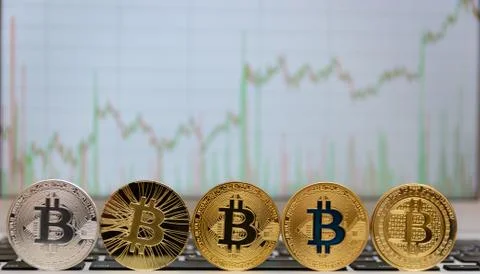 Bitcoins stand on notebook keyboard Stock Photos