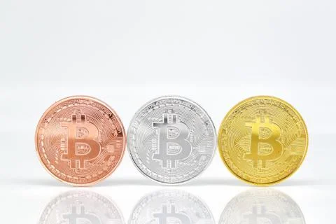 Bitcoins on white background with reflection Stock Photos