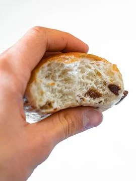 Bite off of bun with raisins. White background Stockfoto's