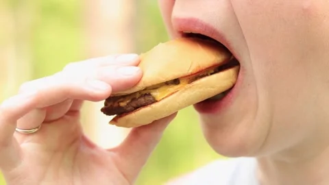 Bite a burger close-up Stock Footage 241244832