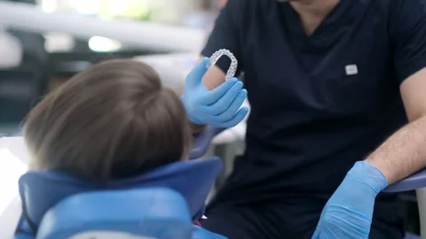 Bite correction in modern dentistry clinic orthodontist showing female patient Stock Footage 240658261