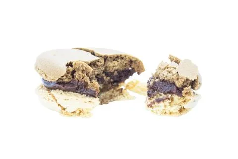 Bite crispy macaron with latte coffee flavour Stock Photos