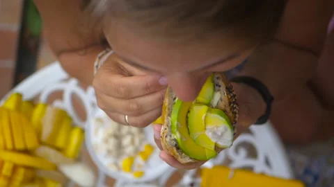 Bite into a delicious healthy mango sandwich. 1920x1080. full hd Stock Footage 138954402