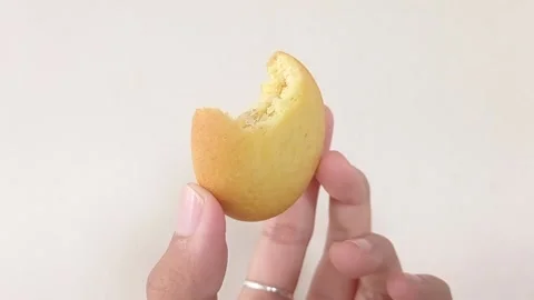 A bite of pineapple biscuit with a white background Stock Footage 146249806