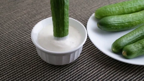 Bite size cucumber being dipped in ranch dressing Stock Footage 82315391