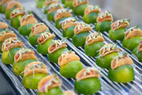 Bite Size Tacos Resting on Lime Wedges Served On a Tray Stock Photos