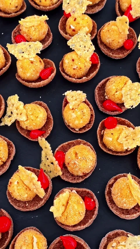 Bite-sized gourmet appetizers with spicy chili peppers and crispy cheese topping Stock Footage 337387826