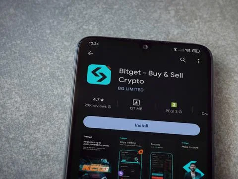 Bitget app play store page on smartphone on ceramic stone background Stock Photos