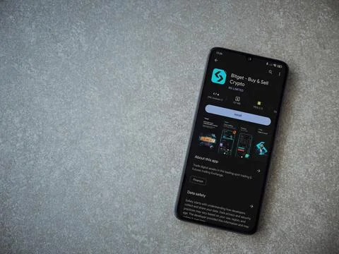 Bitget app play store page on smartphone on ceramic stone background Stock Photos