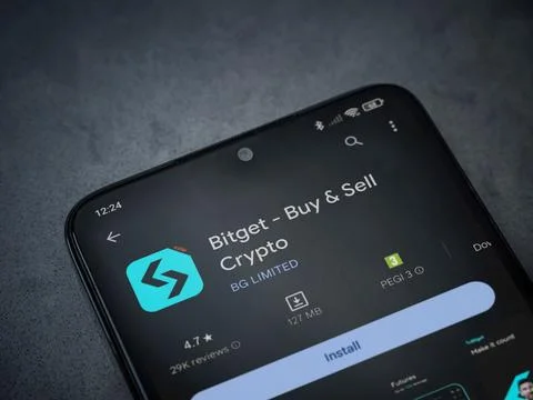 Bitget app play store page on smartphone on a dark marble stone background Stock Photos