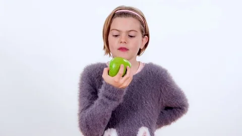 Biting into a big green apple Stock Footage 83724343