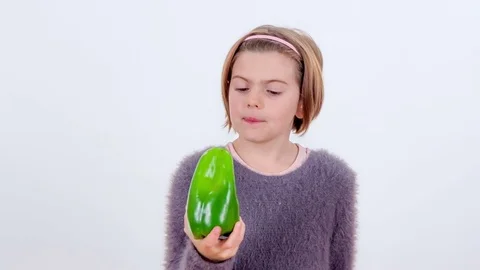 Biting into a big green pepper Stock Footage 83724351