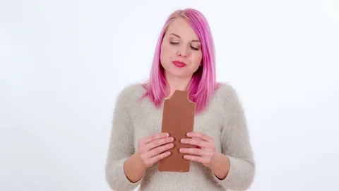 Biting into a big milk chocolate Stock Footage 83724639