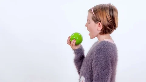 Biting into a green apple Stock Footage 83724334
