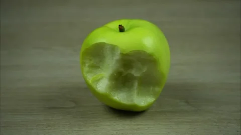 Biting a green apple piece by piece. StopMo Stock Footage 245581095