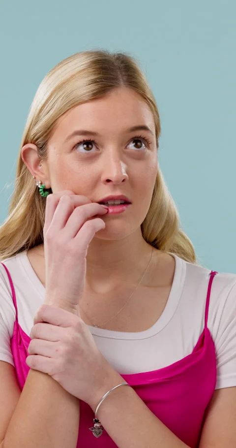 Biting nails, face and nervous with woman in studio for anxiety, concern or Stock Footage 340455718