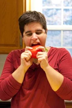 Biting into red pepper Stock Photos