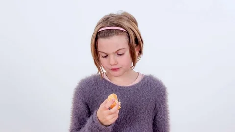 Biting into a tangerine Video stock 83724342