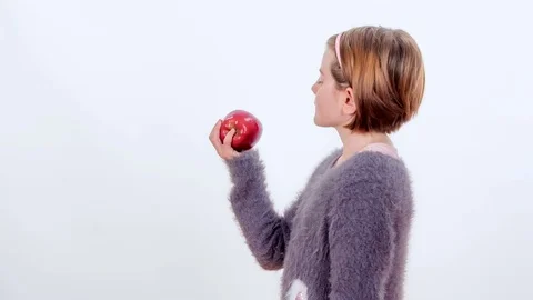 Biting into a tasty red apple Stock Footage 83724747