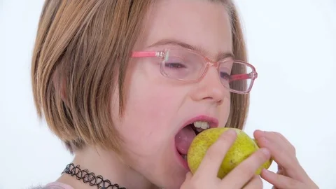 Biting into a yellow pear and really liking the taste of it Stock Footage 83724921