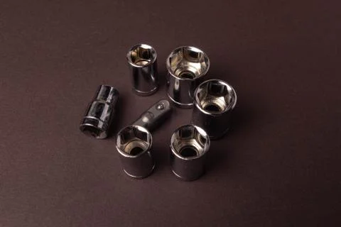 Bits bits for tightening screws of different sizes on a brown background. Stock Photos