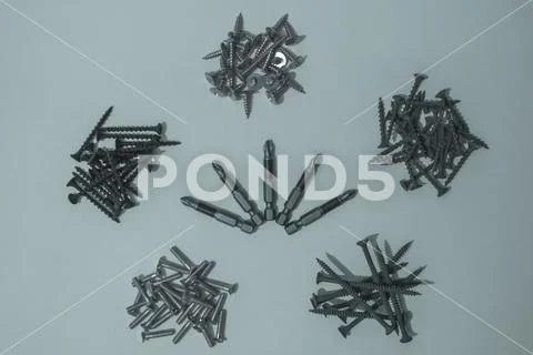 Bits for screwdriver and cogs. Stock Photos