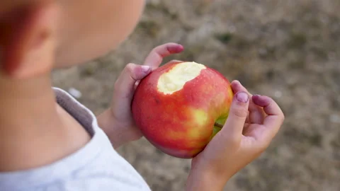 A bitten apple in his hand. Boy with an apple. Boy with an apple. Stock Footage 201088946