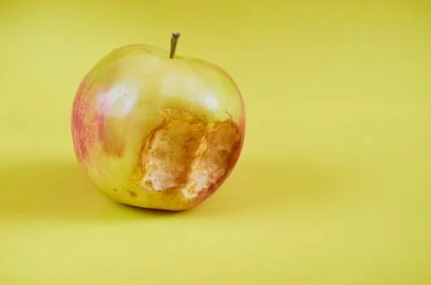 A bitten Apple lies on a colored background Stock Photos