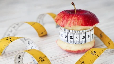 Bitten Apple Wrapped in Measuring Tape Diet Concept Stock Footage 336111057