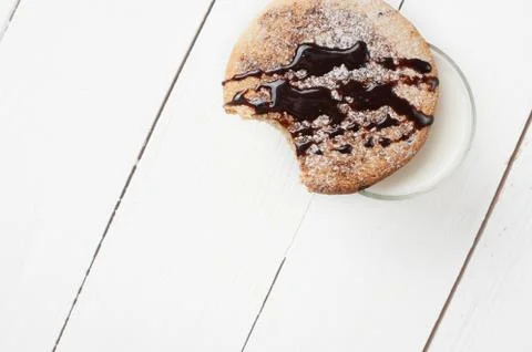 Bitten biscuits with icing and sugar powder. Stock Photos