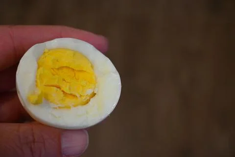 Bitten boiled egg in hand close-up Stockfoto's