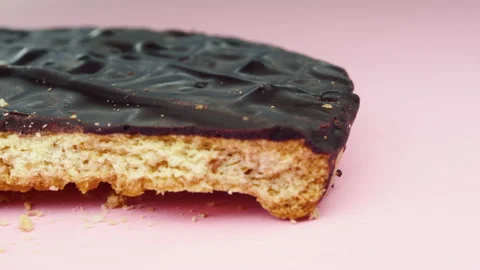 Bitten Chocolate biscuits panning on pink background.4k macro detail Stock Footage 155284852