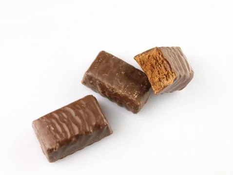 Bitten chocolate candy on a white background. Stock Photos