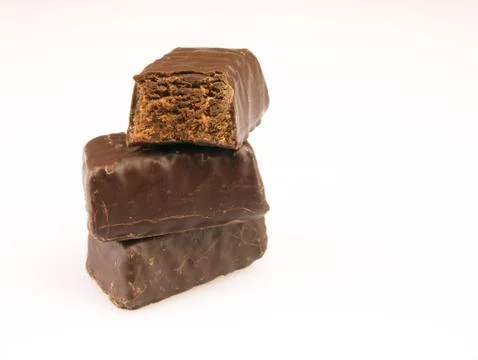 Bitten chocolate candy on a white background. Stockfoto's