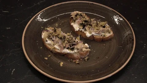 Bitten off fish bruschetta above view Stock Footage 113528632