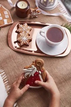 Bitten gingerbread cookie of St Nicholas in childs hands. Atmoshperic seasonal Stock Photos