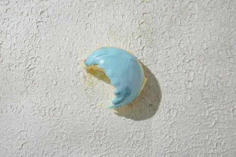 Bitten mini donut with a bite mark visible, set against a textured white ba.. Stock Photos